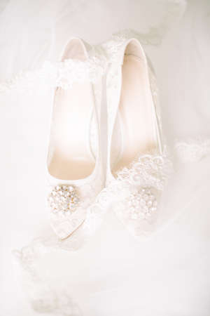 Bridal shoes on tulle. Gemstone and lace.の写真素材