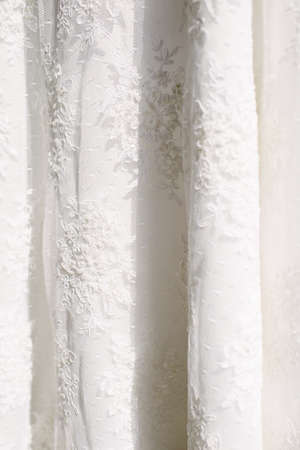 A white wedding dress hanged on the hanger. Preparations for the wedding day.の写真素材