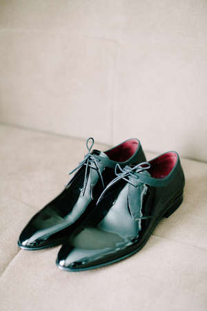 Black patent leather wedding shoes. Wedding reparations details. Indoor and close up.の写真素材