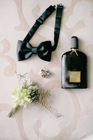 Groom accessories. Bow tie, boutonniere, seat and bow tie. Indoor and close-up.の写真素材