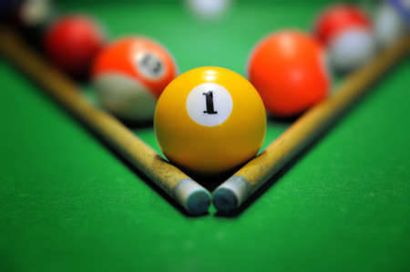 Billiard balls in a green pool tableの写真素材