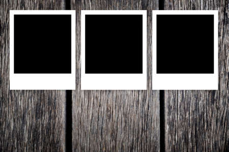 Blank instant photo frames on old wooden backgroundの写真素材