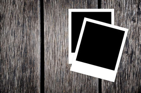 Blank instant photo frames on old wooden backgroundの写真素材