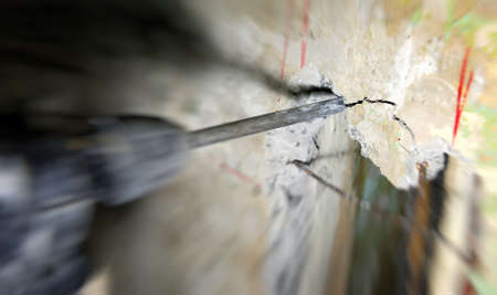 Construction worker making hole a using pneumatic hammerの写真素材