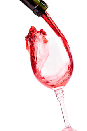 red wine pouring into wine glassの写真素材