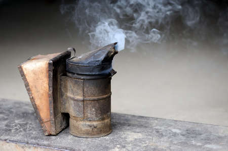 Closeup of bee smoker on crate at farmの写真素材