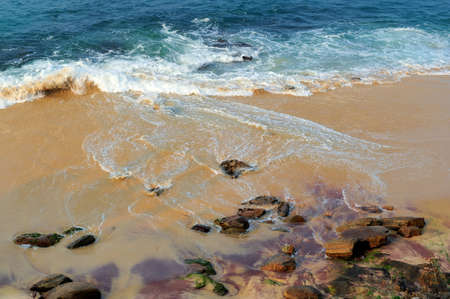 Wave of the ocean on the sand beachの写真素材