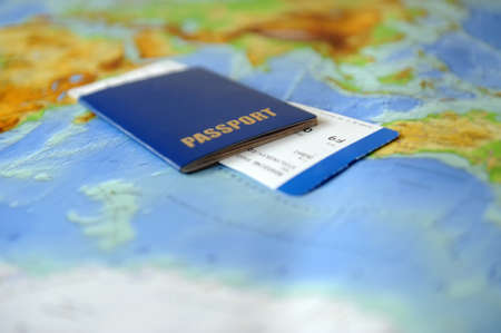 Passport and ticket  on a background map of the world. Traveling conceptの写真素材