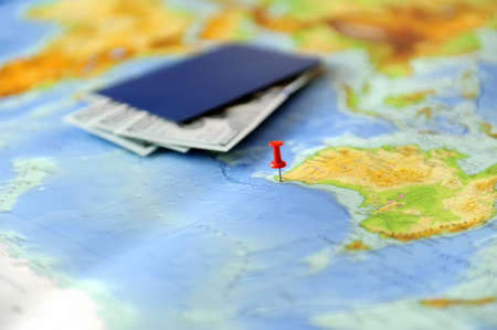 Passport and money on a background map of the world. Traveling conceptの写真素材