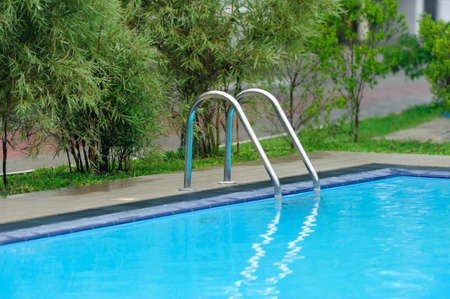 Swimming pool with stair at hotel close up