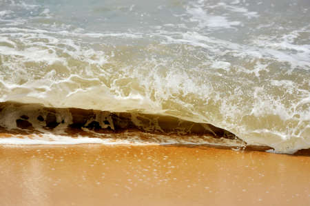 Wave of the ocean on the sand beachの写真素材