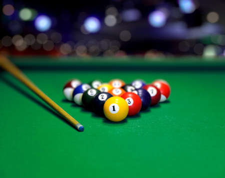 Billiard balls in a green pool table