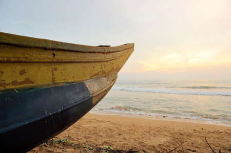 Fishing boats resting on empty beach in Sri Lanka