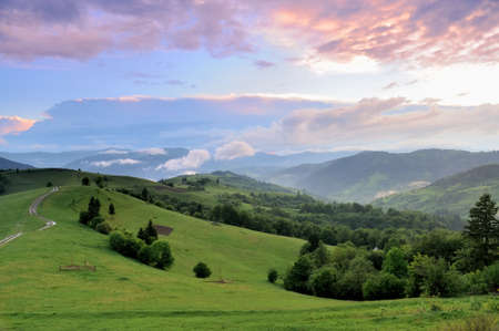 Beautiful summer landscape in the mountains with the sun at dawnの写真素材