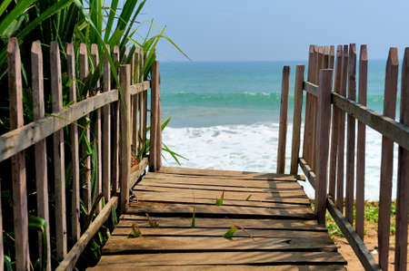 Wooden platform beside tropical beach