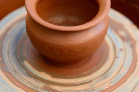 Hands of a potter. Potter making ceramic pot on the pottery wheelの写真素材