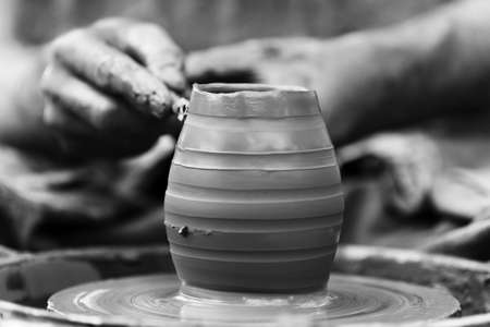 Hands of a potter. Potter making ceramic pot on the pottery wheelの写真素材
