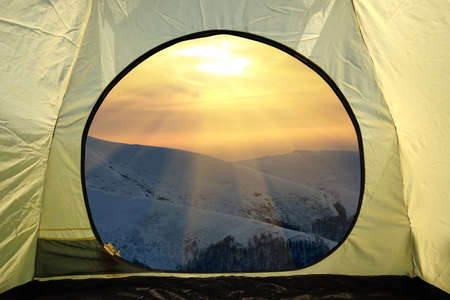 View from inside a tent on mountains landscape. Travel lifestyle concept adventure vacations outdoorの写真素材