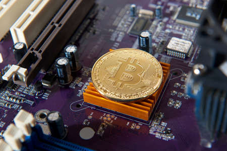 Gold Bitcoin electronic computer processor board. Virtual cryptocurrency conceptの写真素材