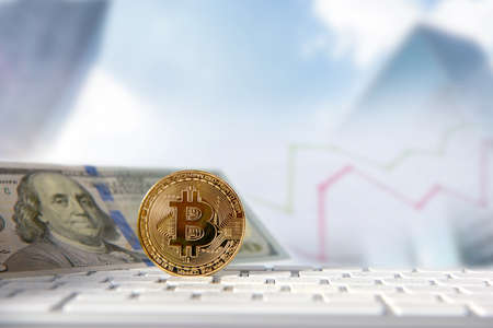 Bitcoin golden coin with financial chart and dollar background. Cryptocurrency