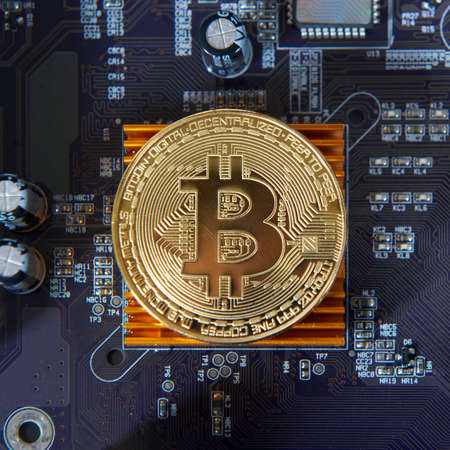 Gold Bitcoin electronic computer processor board. Virtual cryptocurrency conceptの写真素材