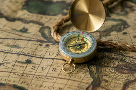 Old compass on vintage map with rope closeup. Retro staleの写真素材