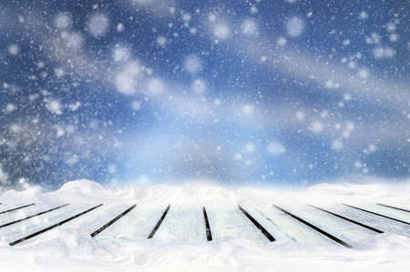 Greeting winter blurred background with wooden table and snowflakes. Merry christmas and New year...