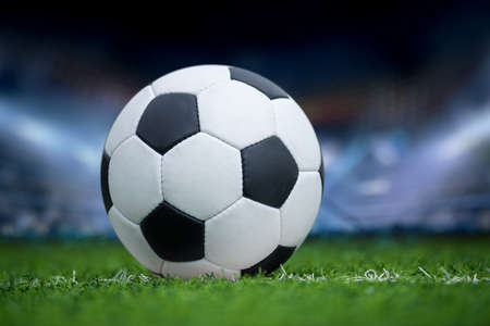 Closeup soccer ball in green grass on stadium 