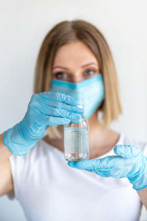 Bottle for injection in nurse hand. Medical glass vial for vaccination. Science equipment, liquid...