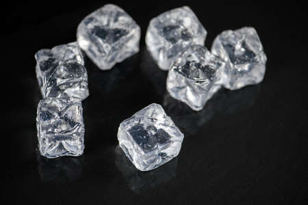 Ice cubes square with drops water clean on black backgroundの写真素材