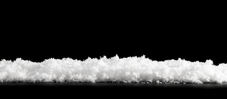 Close white snow isolated on black backgroundの写真素材