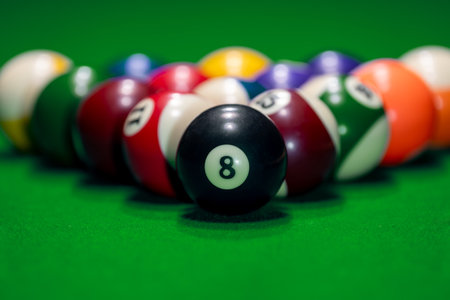 Close many colorful billiard balls and cue on green tableの写真素材