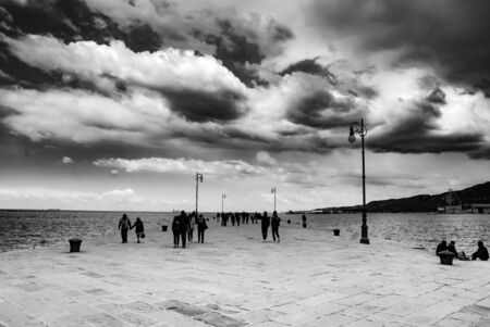 Black and white picture of a pier at the sea, Trieste, Italy