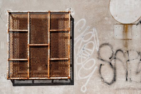 Window with rusty bars and graffiti on a prisonの写真素材