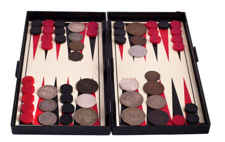 Backgammon and old coins isolated on white background