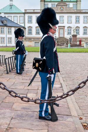 Fredensborg, Denmark - August 6, 2010: Royal guards changing on Fredensborg palace at August 6, 2010 in Fredensborg, Denmark - in nasty weather.のeditorial素材