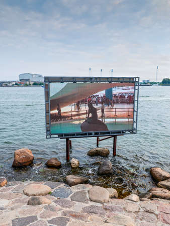 Copenhagen, Denmark - August 5, 2010: Little Mermaid statue in Copenhagen is not in place as it was taken to an exhibition in China. Sculpture show on the screen from China. The Copenhagen City Council arranged to move the statue to Shanghai at the Danishのeditorial素材