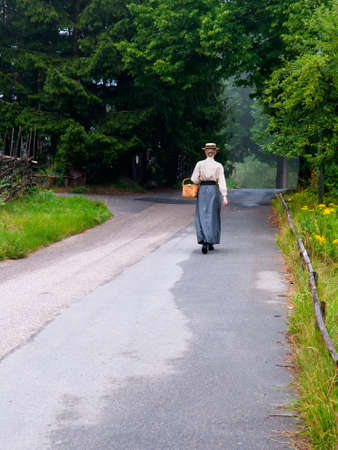 Stockholm, Sweden - July 28, 2010:  The girl in the dress of the 18th century is on the Skansen open-air museum and zoo on the island of Djurgarden in Stockholm, Sweden.のeditorial素材