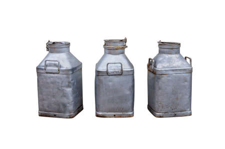 Old milk churns isolated on whiteの写真素材