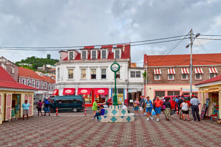 St. George's, Grenada - December 3, 2011: Scene of daily life in the capital of Grenada, with people walking on the sidewalks and traffic in the streets. The center of the city full of shops and people - residents and tourists.のeditorial素材