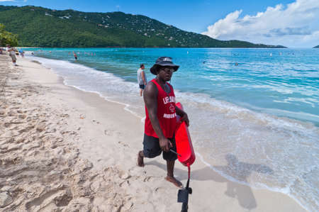 Magens Bay, St. Thomas, U.S. Virgin Islands - December 5, 2011: A red cross lifeguard is patrolling the Magens Bay beach, St. Thomas, U.S.V.I.のeditorial素材