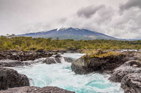 The Petrohue Falls and Osorno Volcano with its snow peak in Puerto Varas in cloudy weather, south of Chile.の写真素材
