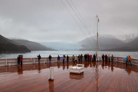 Amilia Glacier, South Patagonia, Chile - December 8, 2012: Passengers on board the cruise ship...