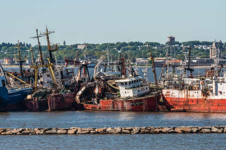 Montevideo, Uruguay - December 15, 2012: The abandoned old rusty ship in the Port of Montevideo, Uruguay at December 15, 2012. Montevideo in the background.のeditorial素材