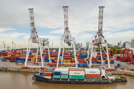 Buenos Aires, Argentina - December 16, 2012: Cargo ships with shipping containers at a container terminal in Puerto Nuovo, Buenos Aires, Argentina on a overcast weather.のeditorial素材