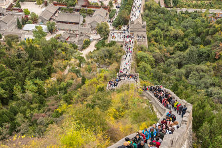 Beijing, China - October 14, 2013: A view of the Great Wall in Beijing, China. The Visitors are both locals and foreigners. They walk up and down the steep stairs on a cloudy day.のeditorial素材