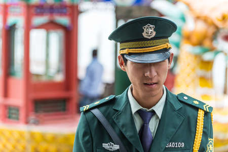 Beijing, China - October 14, 2013: A Chinese guard, from the Beijing Public Security Bureau (PSB), patrolling the area of the Summer Palace, Beijing, China.のeditorial素材