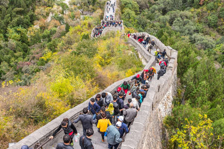 Beijing, China - October 14, 2013: A view of the Great Wall in Beijing, China. The Visitors are both locals and foreigners. They walk up and down the steep stairs on a cloudy day.のeditorial素材