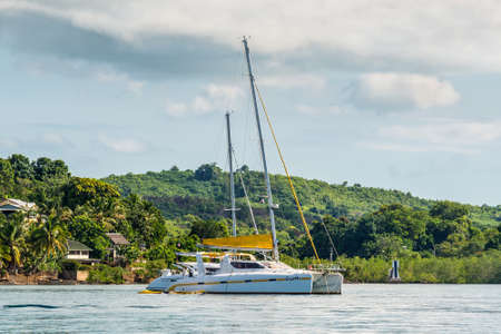 Hell-Ville, Madagascar - December 19, 2015: Yacht catamaran Coyotte anchored at Hell-Ville, Nosy Be...