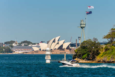 Sydney, Australia - November 9, 2014: The Sydney Opera House from ferry passing Bradleys Head lighthouse and HMAS Sydney memorial mast, Sydney, NSW, Australia.のeditorial素材